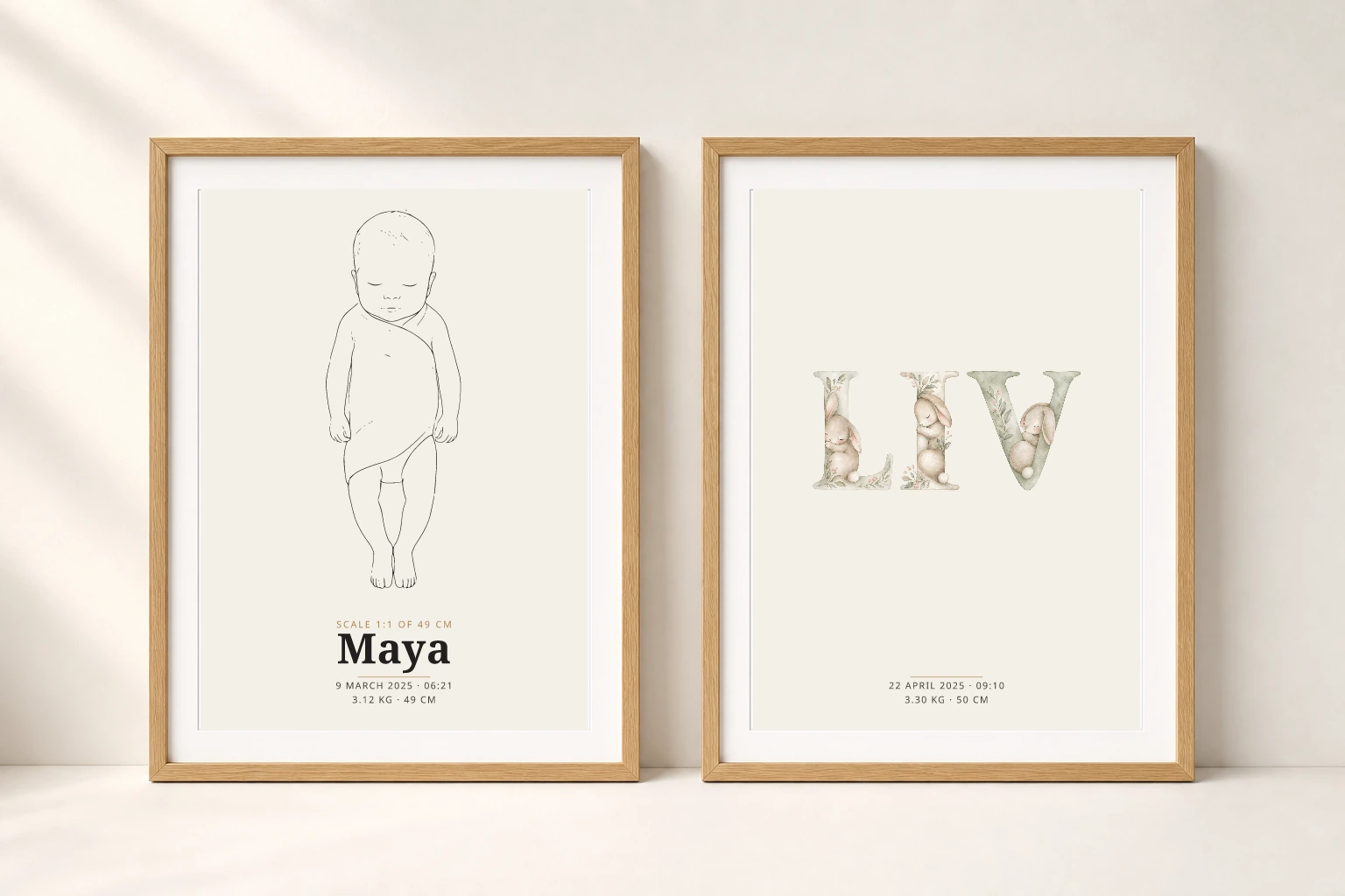 Two oak-framed birth posters showing a life-size baby drawing and the illustrated name Liv