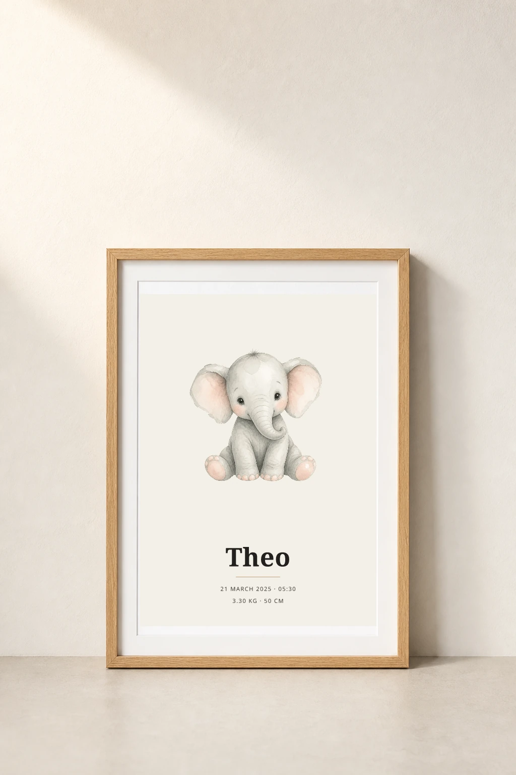An oak-framed personalised watercolor elephant birth poster for Theo